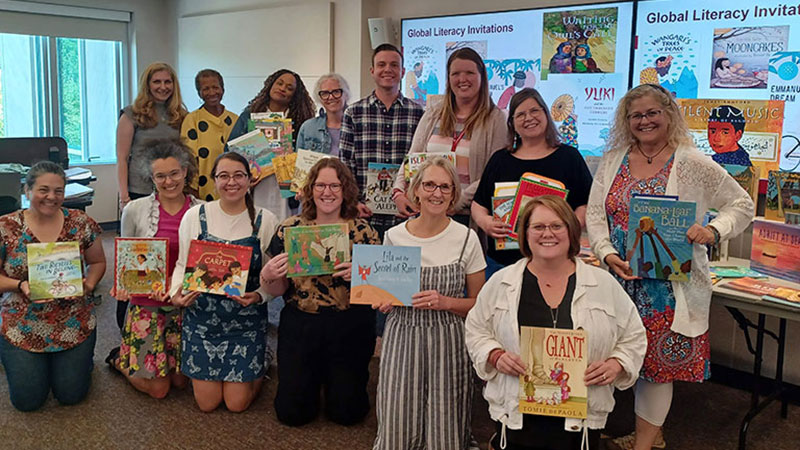 Group of teachers posing with books
